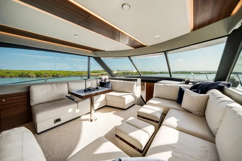 Godspeed Yacht Photos Pics Luxurious interior of 2024 Maritimo M55 yacht with panoramic windows and plush seating.