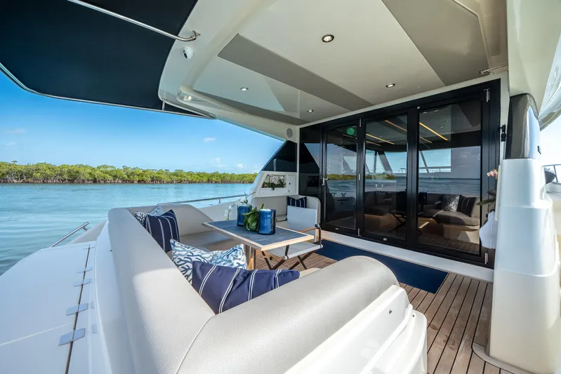 Godspeed Yacht Photos Pics 2024 Maritimo M55 yacht deck with luxurious seating and scenic water view.