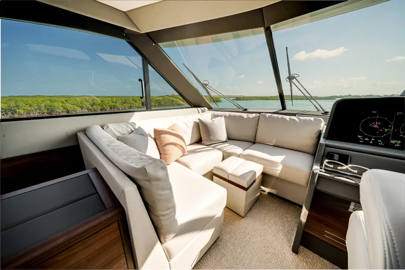 Godspeed Yacht Photos Pics Luxurious interior of 2024 Maritimo M55 yacht with plush seating and panoramic windows.