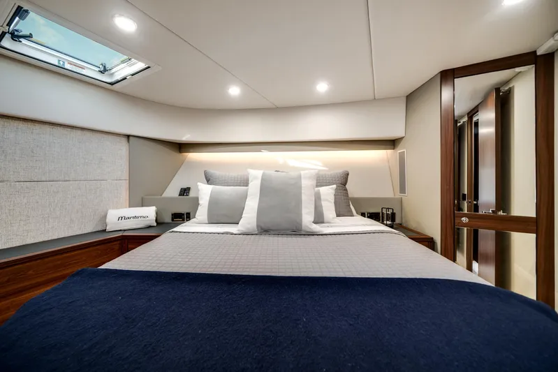 Godspeed Yacht Photos Pics Luxurious 2024 Maritimo M55 yacht bedroom with modern design and elegant bedding.