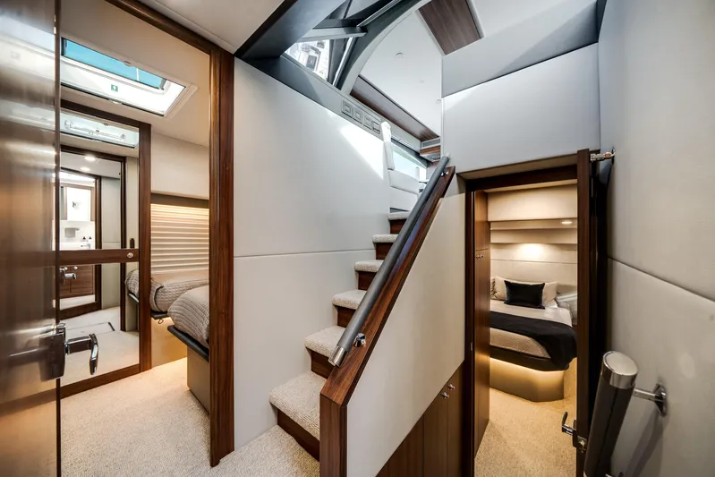Godspeed Yacht Photos Pics Luxurious interior of 2024 Maritimo M55 yacht with elegant bedrooms and staircase.