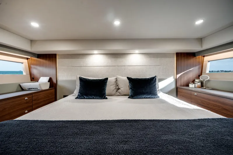 Godspeed Yacht Photos Pics Luxurious 2024 Maritimo M55 yacht bedroom with elegant wood accents and ocean view.
