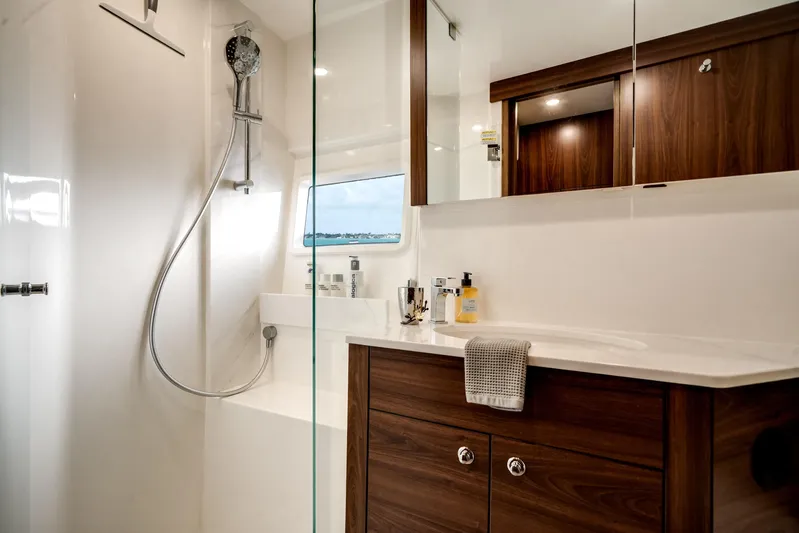 Godspeed Yacht Photos Pics Luxurious bathroom in 2024 Maritimo M55 yacht with modern fixtures and wooden cabinetry.