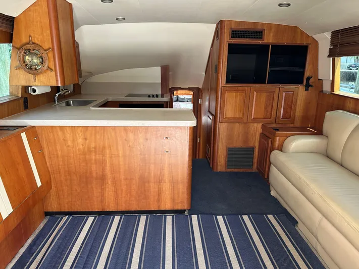 Yacht Photos Pics Interior of 2003 Luhrs 40 Convertible yacht with wood cabinetry and striped carpet.