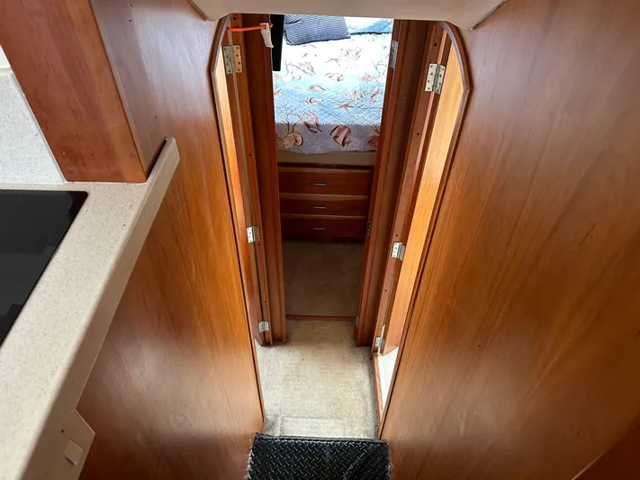  Yacht Photos Pics Interior hallway of 2003 Luhrs 40 Convertible yacht with wooden doors and carpeted floor.