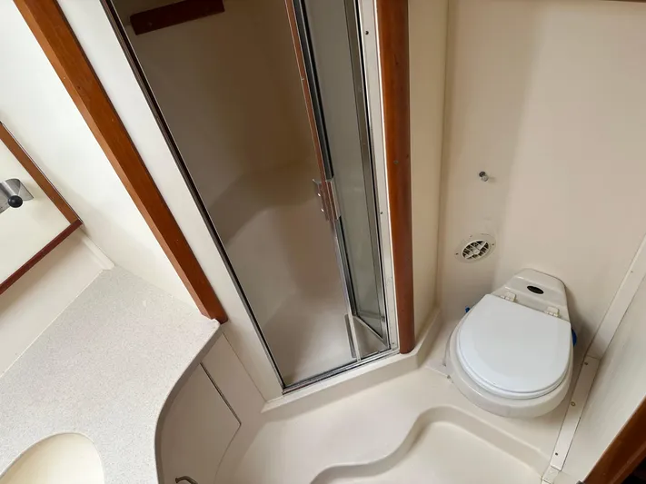  Yacht Photos Pics 2003 Luhrs 40 Convertible yacht bathroom with shower, toilet, and sink.