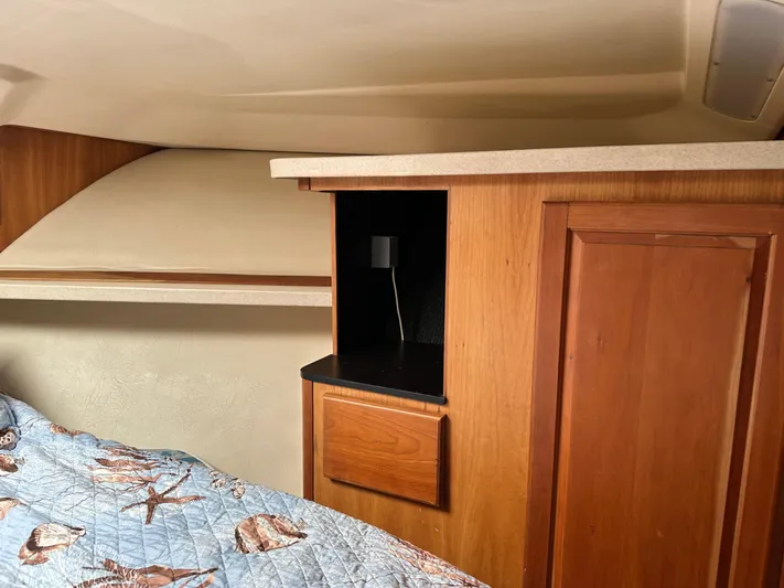  Yacht Photos Pics 2003 Luhrs 40 Convertible cabin interior with wood cabinetry and bed.