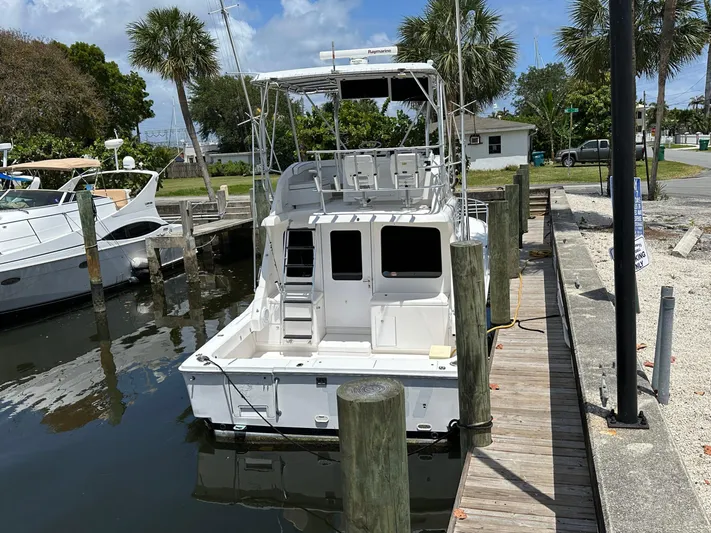  Yacht Photos Pics 2003 Luhrs 40 Convertible boat docked at a marina, surrounded by palm trees.