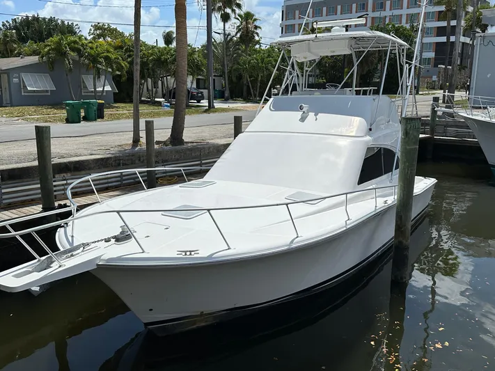  Yacht Photos Pics 2003 Luhrs 40 Convertible boat docked in a marina, featuring a sleek white design.