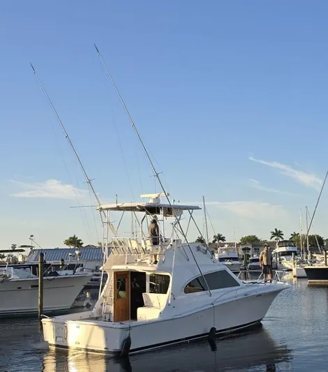  Yacht Photos Pics 2003 Luhrs 40 Convertible boat docked at marina under clear blue sky.