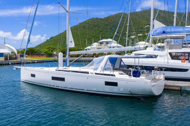 Heartbeat Yacht Photos Pics 2024 Beneteau Oceanis Yacht 54 docked in a scenic marina setting.