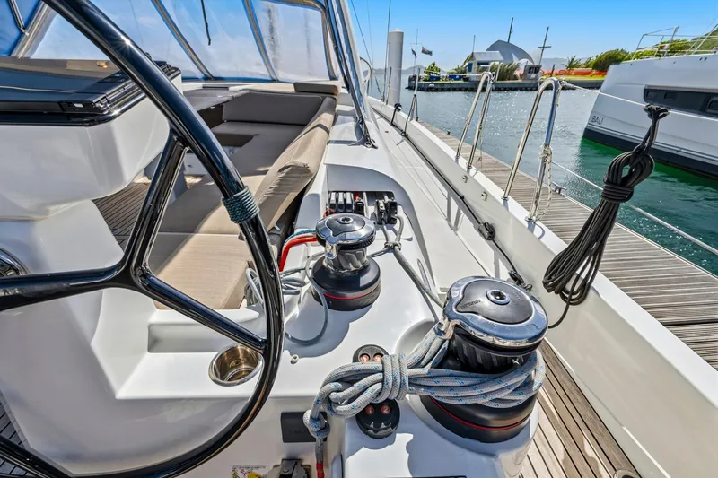 Heartbeat Yacht Photos Pics 2024 Beneteau Oceanis Yacht 54 cockpit with steering wheel and winches, docked at marina.