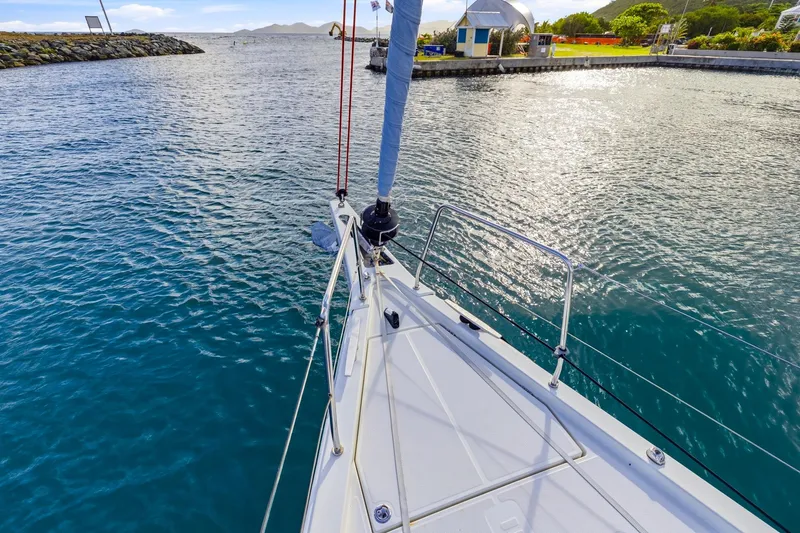 Heartbeat Yacht Photos Pics Bow view of 2024 Beneteau Oceanis Yacht 54 in a serene marina setting.