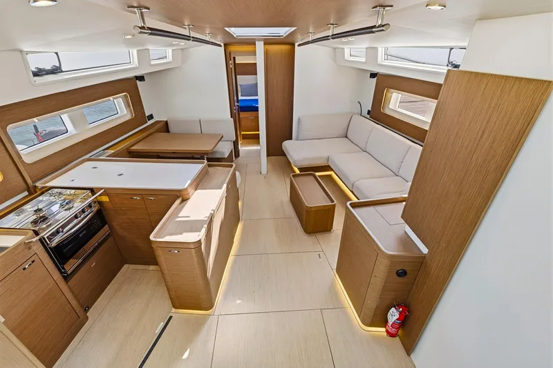 Heartbeat Yacht Photos Pics Luxurious interior of 2024 Beneteau Oceanis Yacht 54 with modern kitchen and seating area.