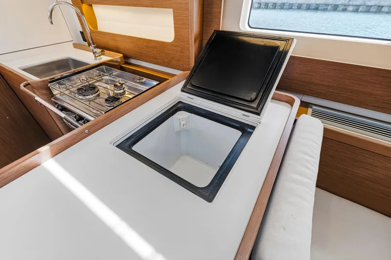 Heartbeat Yacht Photos Pics Modern kitchen area in 2024 Beneteau Oceanis Yacht 54 with stove and sink.