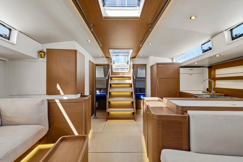 Heartbeat Yacht Photos Pics Luxurious interior of 2024 Beneteau Oceanis Yacht 54, featuring modern wood finishes and spacious design.