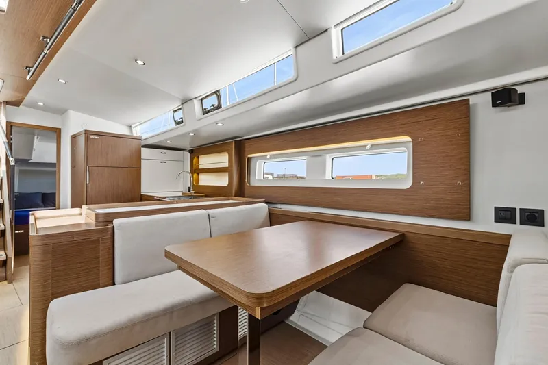 Heartbeat Yacht Photos Pics Luxurious interior of 2024 Beneteau Oceanis Yacht 54 with modern dining area and sleek design.