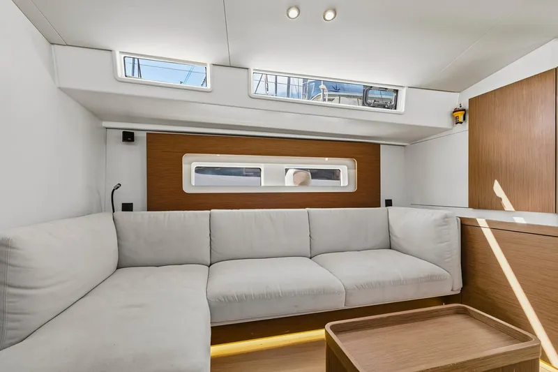 Heartbeat Yacht Photos Pics Luxurious interior of 2024 Beneteau Oceanis Yacht 54 with modern seating and natural light.