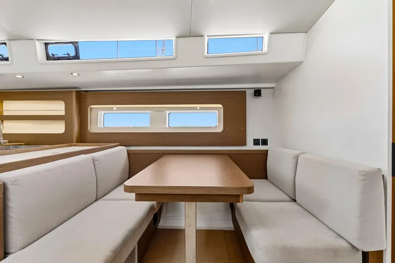 Heartbeat Yacht Photos Pics Interior of 2024 Beneteau Oceanis Yacht 54, featuring elegant dining area with natural light.