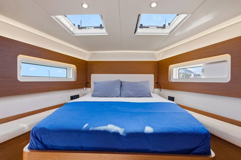Heartbeat Yacht Photos Pics Luxurious cabin interior of 2024 Beneteau Oceanis Yacht 54 with skylights and modern design.