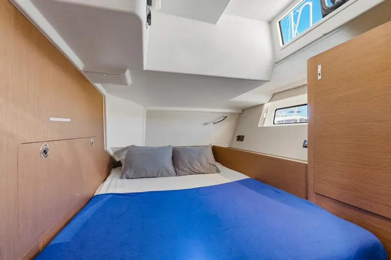 Heartbeat Yacht Photos Pics Luxurious cabin interior of 2024 Beneteau Oceanis Yacht 54 with cozy bedding.