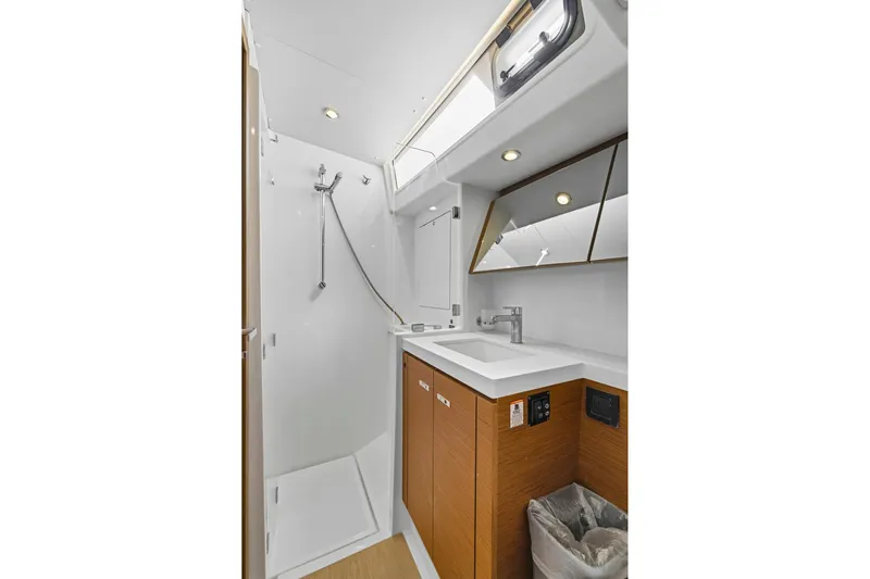 Heartbeat Yacht Photos Pics Modern bathroom in 2024 Beneteau Oceanis Yacht 54, featuring sleek fixtures and wood accents.
