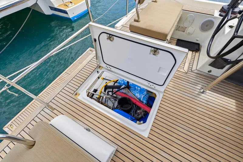 Heartbeat Yacht Photos Pics Open storage compartment on 2024 Beneteau Oceanis Yacht 54, showcasing deck equipment and accessories.