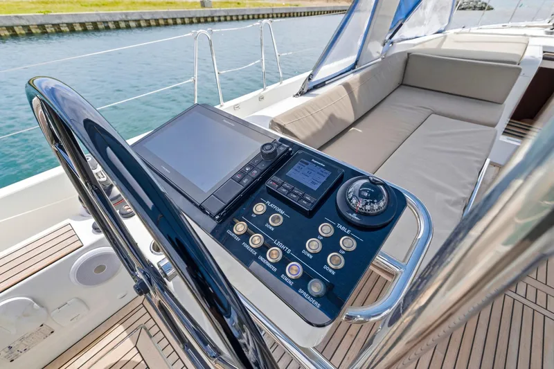 Heartbeat Yacht Photos Pics Helm station of 2024 Beneteau Oceanis Yacht 54 with navigation controls and seating.