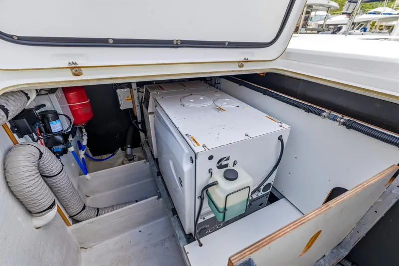 Heartbeat Yacht Photos Pics Engine compartment of 2024 Beneteau Oceanis Yacht 54, showcasing mechanical components and storage.