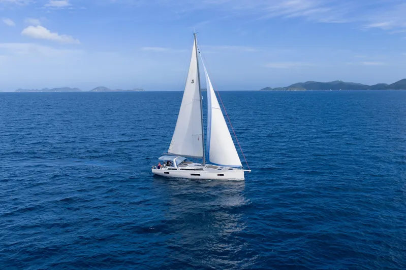 Heartbeat Yacht Photos Pics 2024 Beneteau Oceanis Yacht 54 sailing on open sea under clear blue sky.