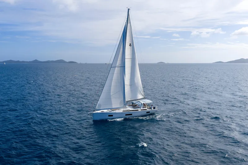Heartbeat Yacht Photos Pics 2024 Beneteau Oceanis Yacht 54 sailing on open sea under clear skies.