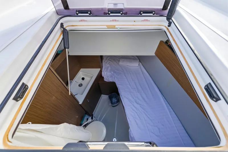 Heartbeat Yacht Photos Pics 2024 Beneteau Oceanis Yacht 54 cabin with bed, sink, and compact design.