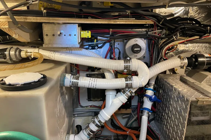  Yacht Photos Pics Engine room of 1988 Chris-Craft 392 Sport Fish with hoses and wiring.