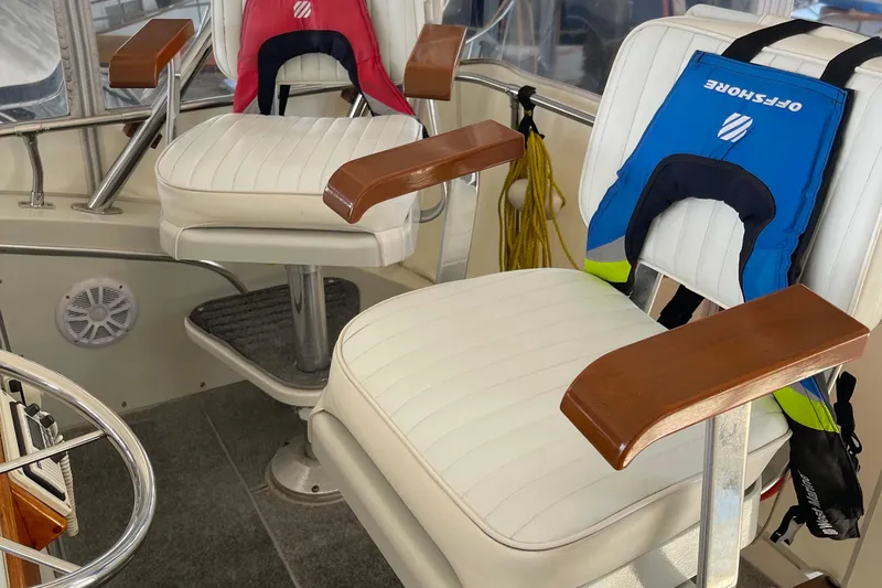  Yacht Photos Pics 1988 Chris-Craft 392 Sport Fish boat interior with white seats and life jackets.