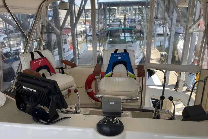  Yacht Photos Pics 1988 Chris-Craft 392 Sport Fish boat interior with helm, seats, and Raymarine equipment.