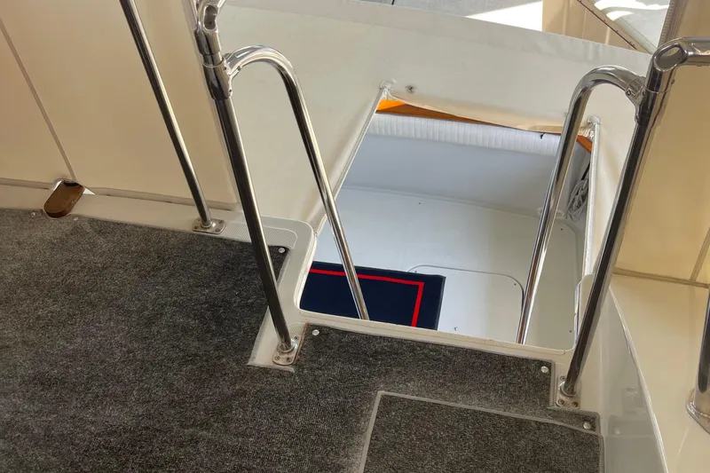  Yacht Photos Pics Interior view of 1988 Chris-Craft 392 Sport Fish boat with carpeted flooring and metal railings.