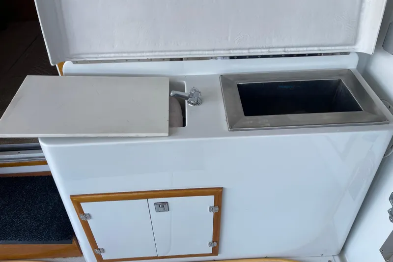  Yacht Photos Pics 1988 Chris-Craft 392 Sport Fish boat interior with sink and storage compartment.