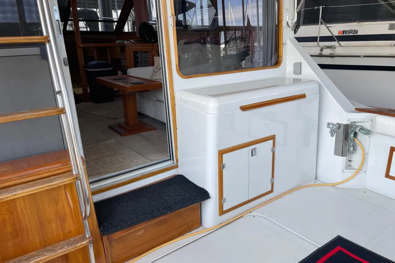  Yacht Photos Pics 1988 Chris-Craft 392 Sport Fish boat interior with wooden accents and seating area.