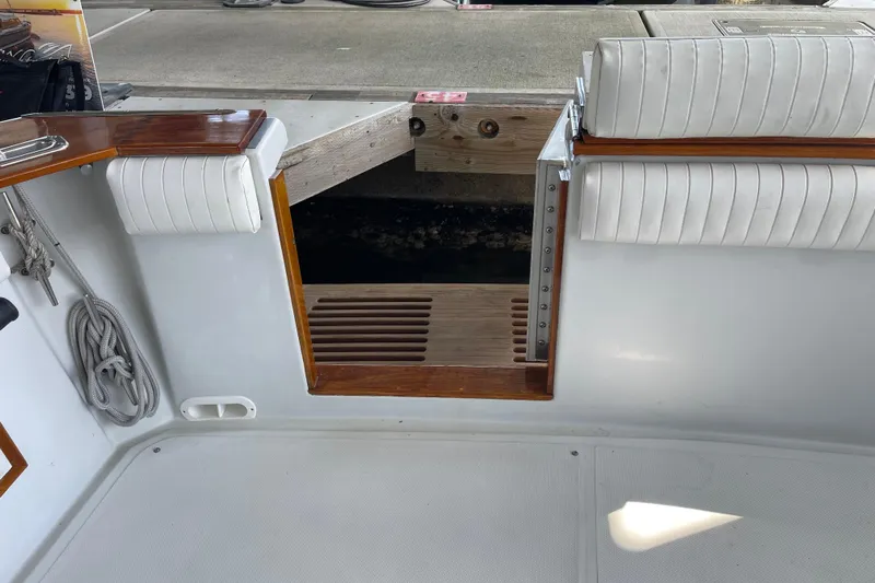  Yacht Photos Pics 1988 Chris-Craft 392 Sport Fish boat interior with white seating and wooden accents.