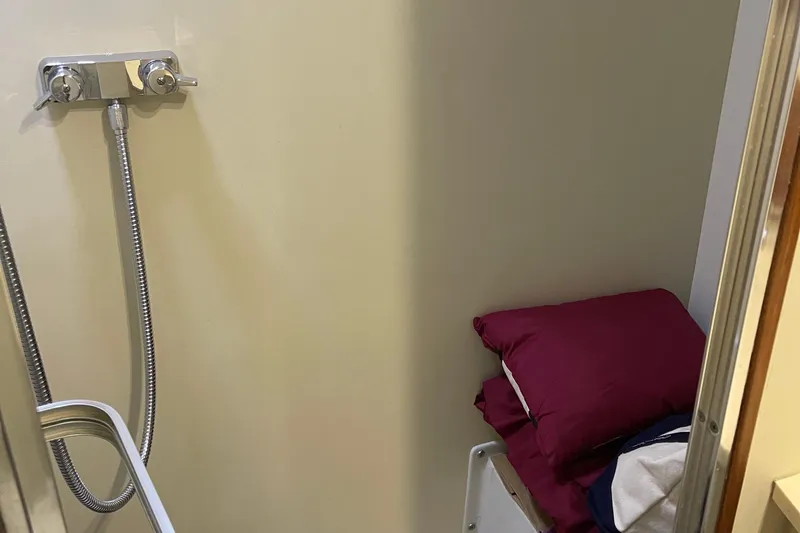  Yacht Photos Pics 1988 Chris-Craft 392 Sport Fish interior with shower and bedding.