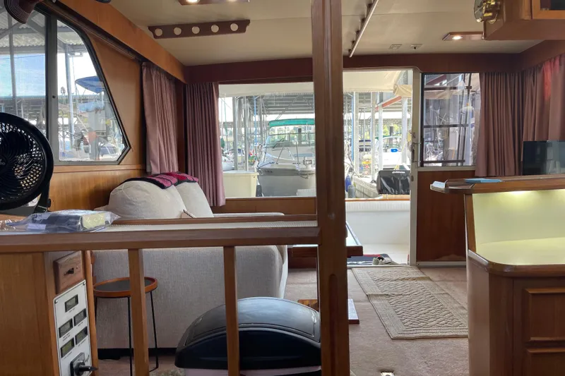  Yacht Photos Pics Interior of 1988 Chris-Craft 392 Sport Fish boat with cozy seating and wooden accents.