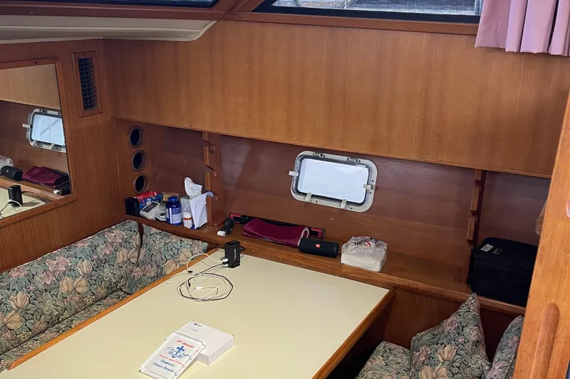  Yacht Photos Pics Interior of 1988 Chris-Craft 392 Sport Fish with wooden paneling and floral seating.