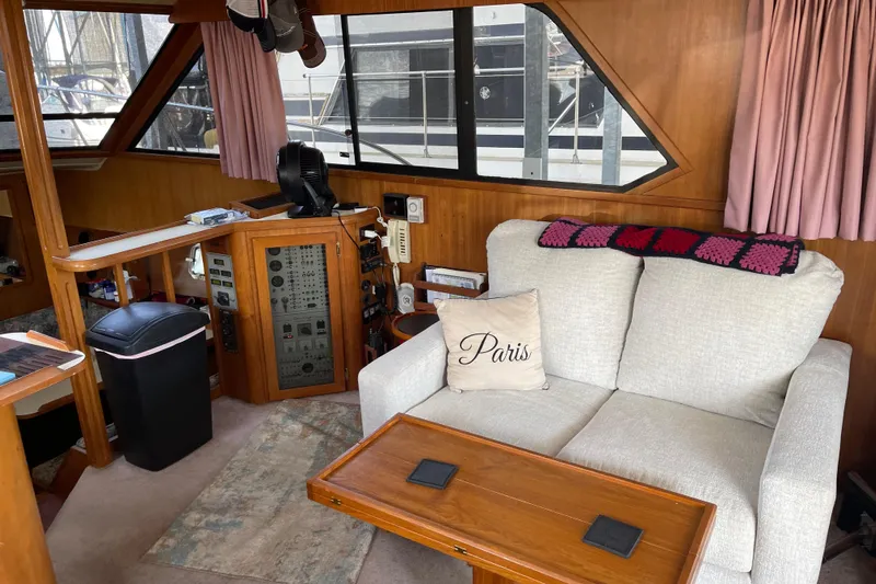  Yacht Photos Pics 1988 Chris-Craft 392 Sport Fish interior with sofa, control panel, and nautical decor.