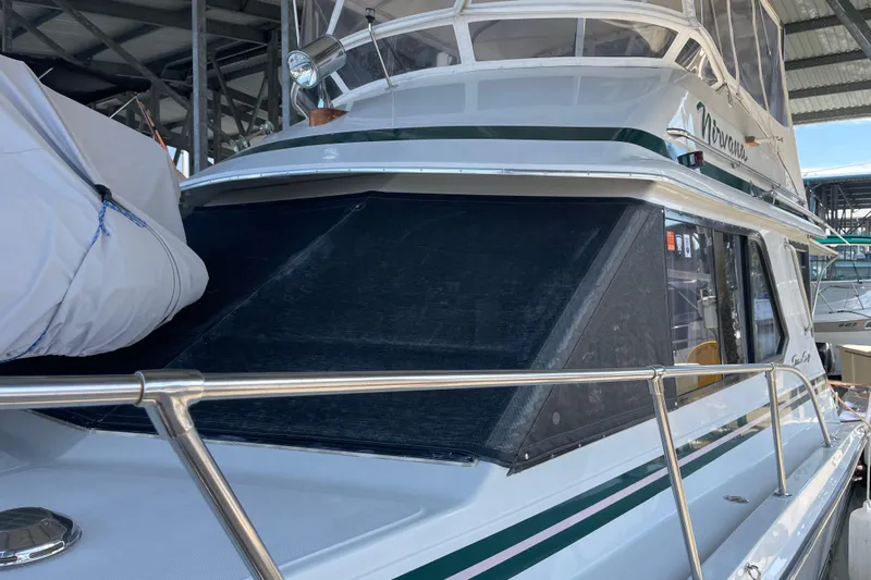  Yacht Photos Pics 1988 Chris-Craft 392 Sport Fish boat docked, featuring sleek design and covered windows.