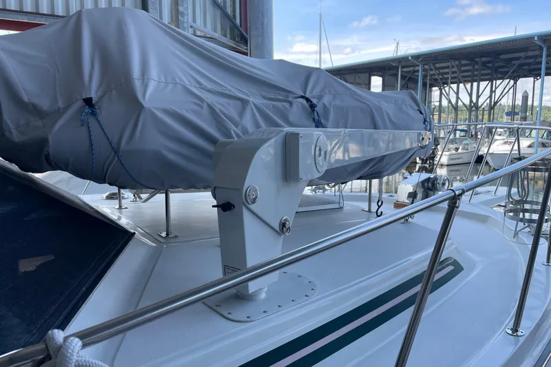  Yacht Photos Pics 1988 Chris-Craft 392 Sport Fish boat deck with covered equipment and marina background.