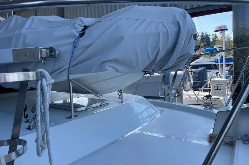  Yacht Photos Pics 1988 Chris-Craft 392 Sport Fish boat deck with covered equipment and marina background.