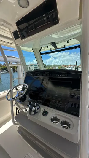  Yacht Photos Pics 2017 Boston Whaler 330 Outrage helm with modern controls and navigation system.