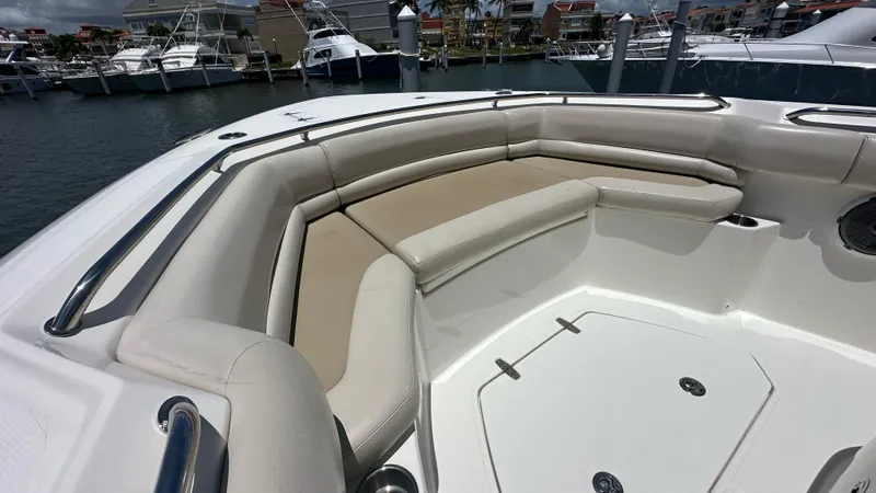 Yacht Photos Pics 2017 Boston Whaler 330 Outrage boat with spacious seating at the bow, docked in a marina.