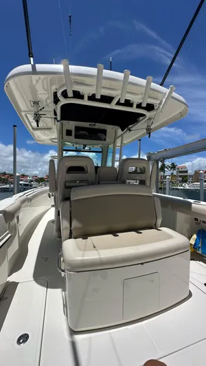  Yacht Photos Pics 2017 Boston Whaler 330 Outrage boat with seating, under a clear blue sky.