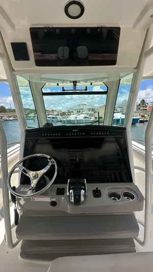  Yacht Photos Pics 2017 Boston Whaler 330 Outrage helm with steering wheel and controls, docked at marina.